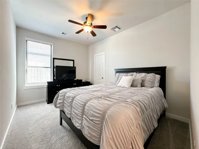 a bedroom with a large bed and a tv