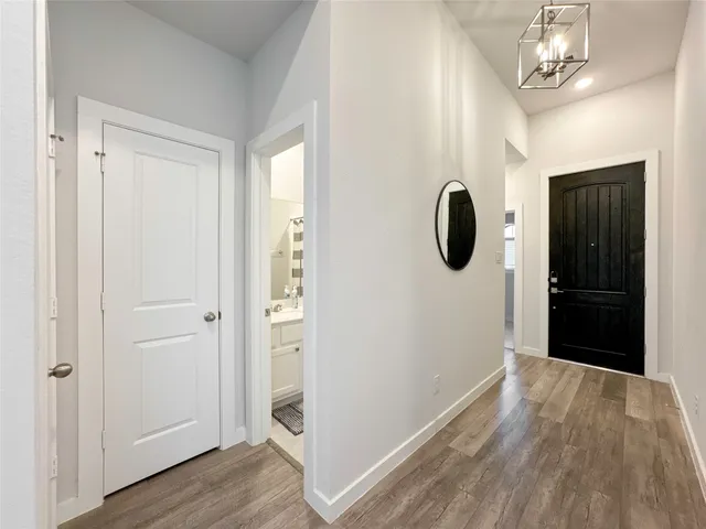a view of a hallway with wooden floor