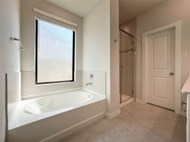 a bathroom with a bathtub and a shower
