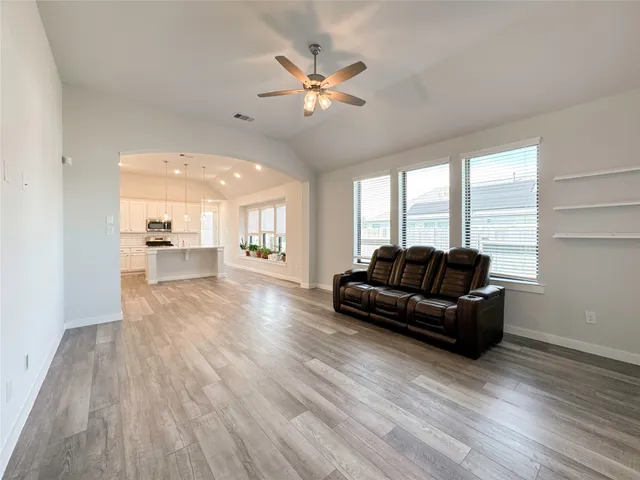 a living room with furniture and a large window