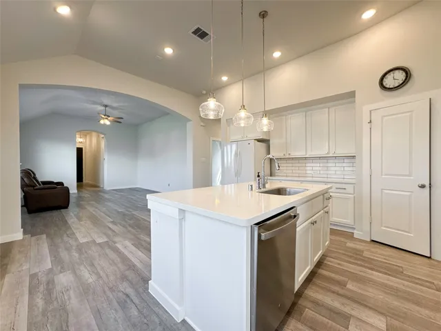 a kitchen with a sink stove and cabinets