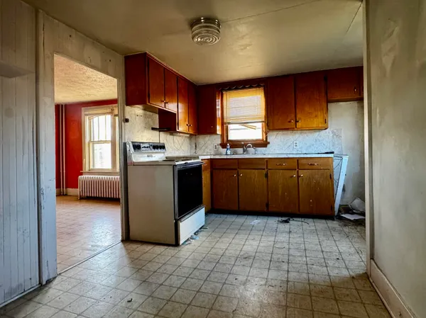 a kitchen with stainless steel appliances granite countertop a stove sink and cabinets