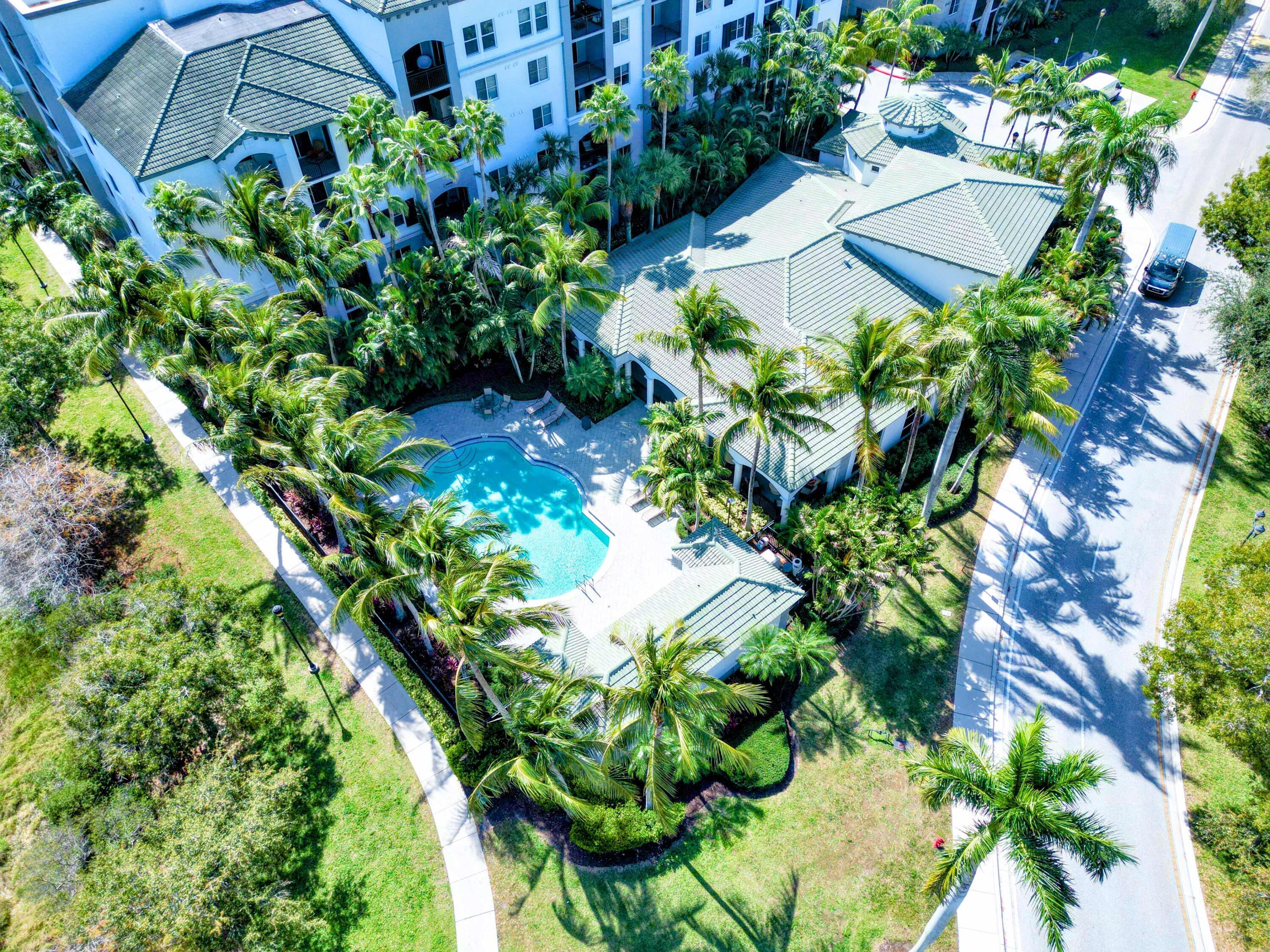 1690 Renaissance Commons Boulevard, Unit 1412 Boynton Beach, FL 33426 - Photo 43 of 49 an aerial view of a house with a yard and garden