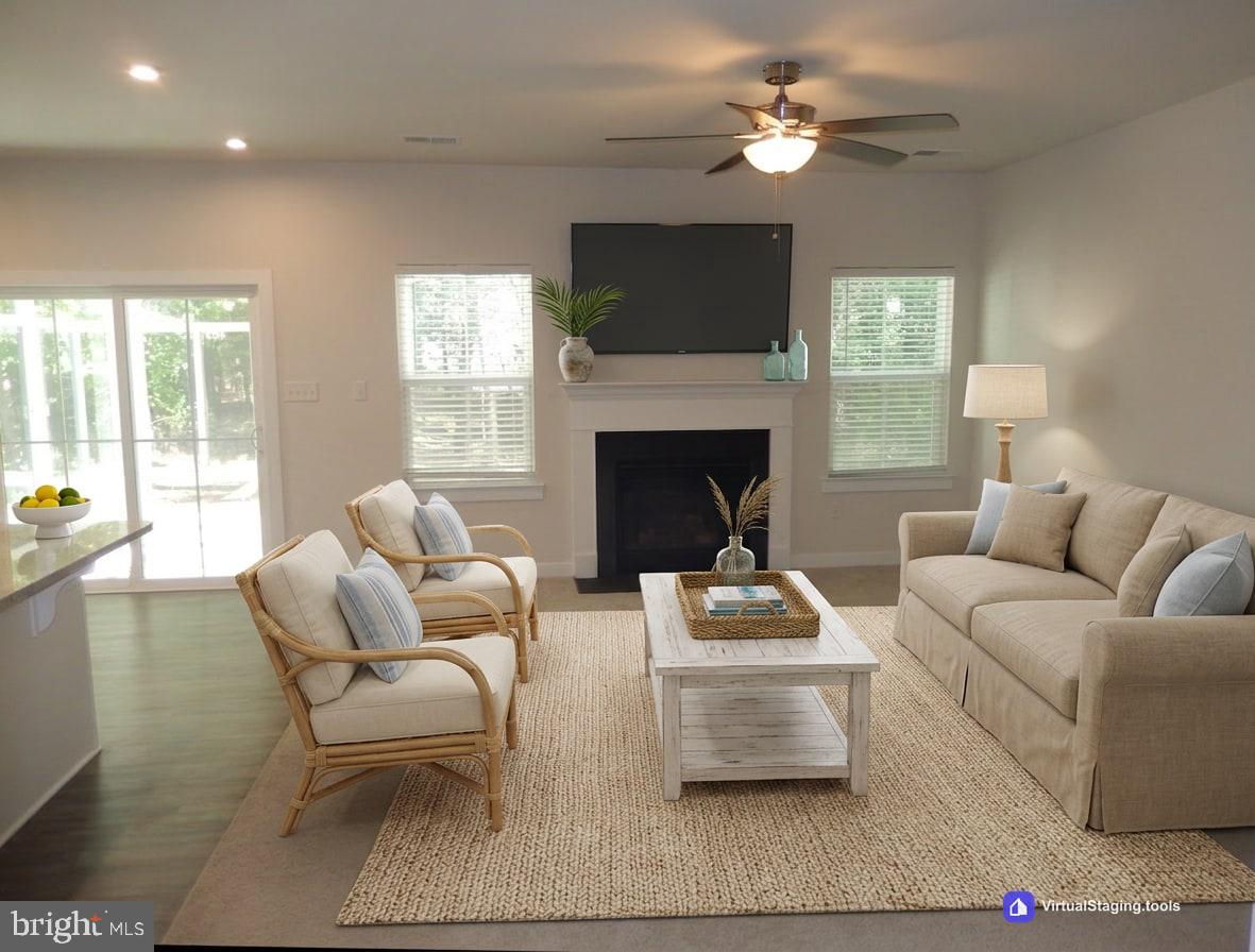 36884 Red Cedar Loop Ocean View, DE 19970 - Photo 7 of 50 a living room with furniture a fireplace and a flat screen tv