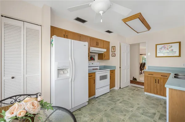 a kitchen with stainless steel appliances a refrigerator and a stove top oven