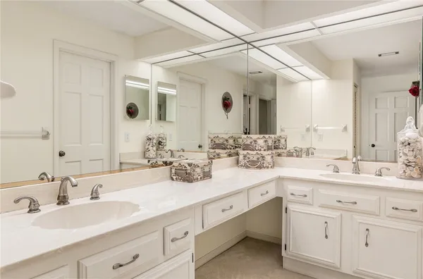 a bathroom with double sink and a mirror