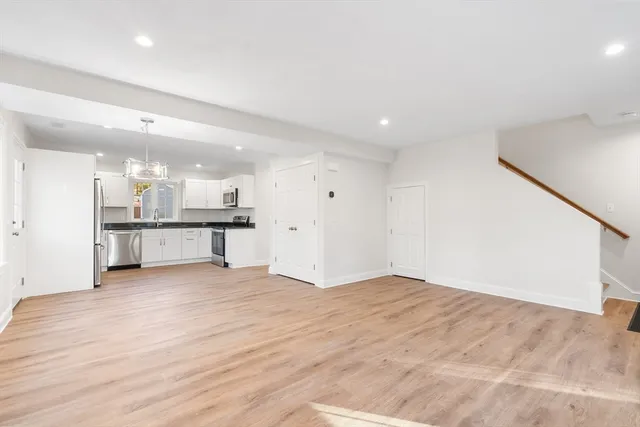 a view of a kitchen with a sink and a refrigerator