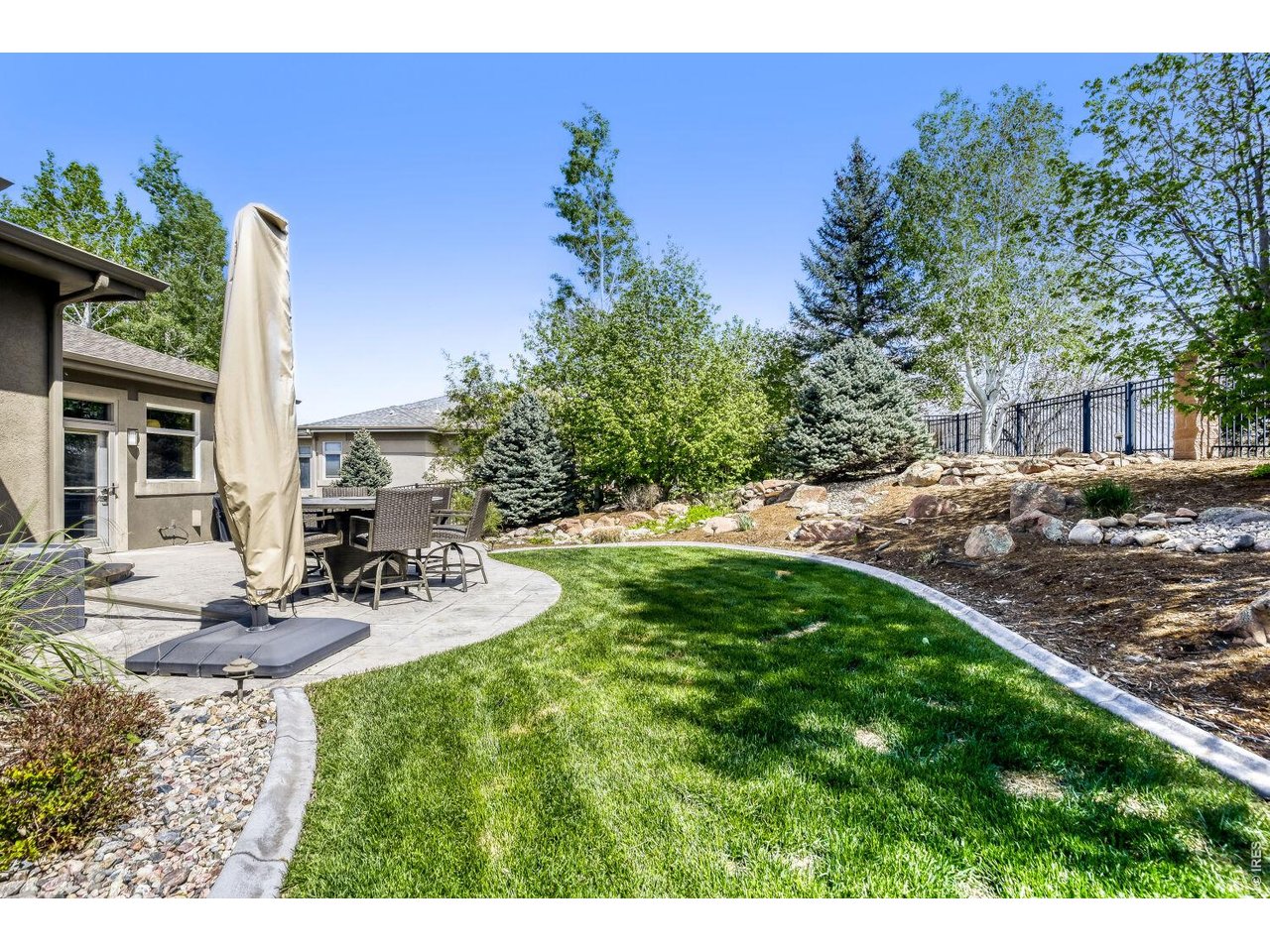 7550 Vardon Way Fort Collins, CO 80528 - Photo 11 of 29 a view of a backyard with plants and patio