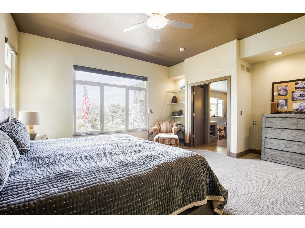 7550 Vardon Way Fort Collins, CO 80528 - Photo 17 of 29 a bedroom with a large bed and a large window