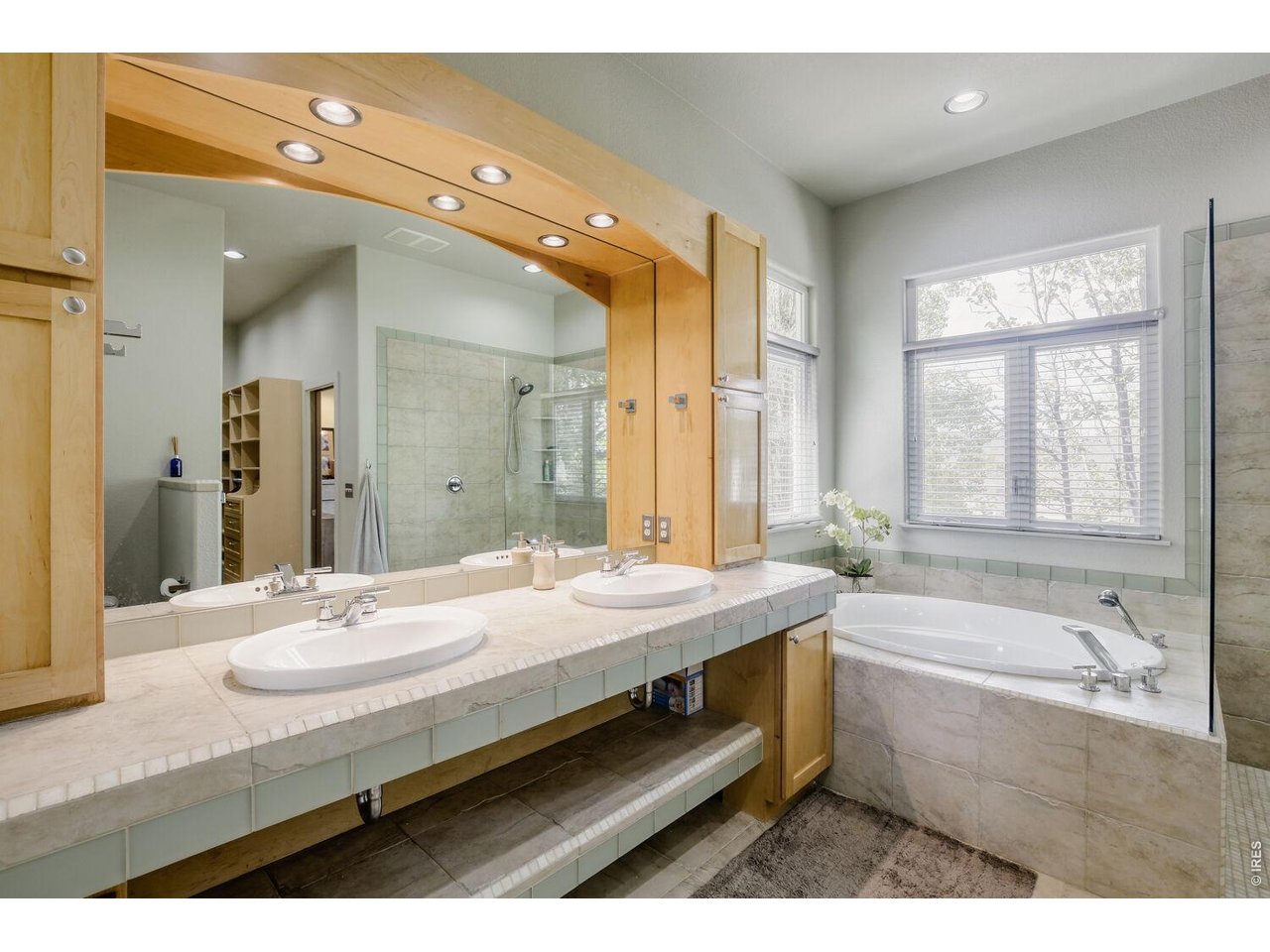 7550 Vardon Way Fort Collins, CO 80528 - Photo 18 of 29 a bathroom with a granite countertop sink a large mirror and a bathtub