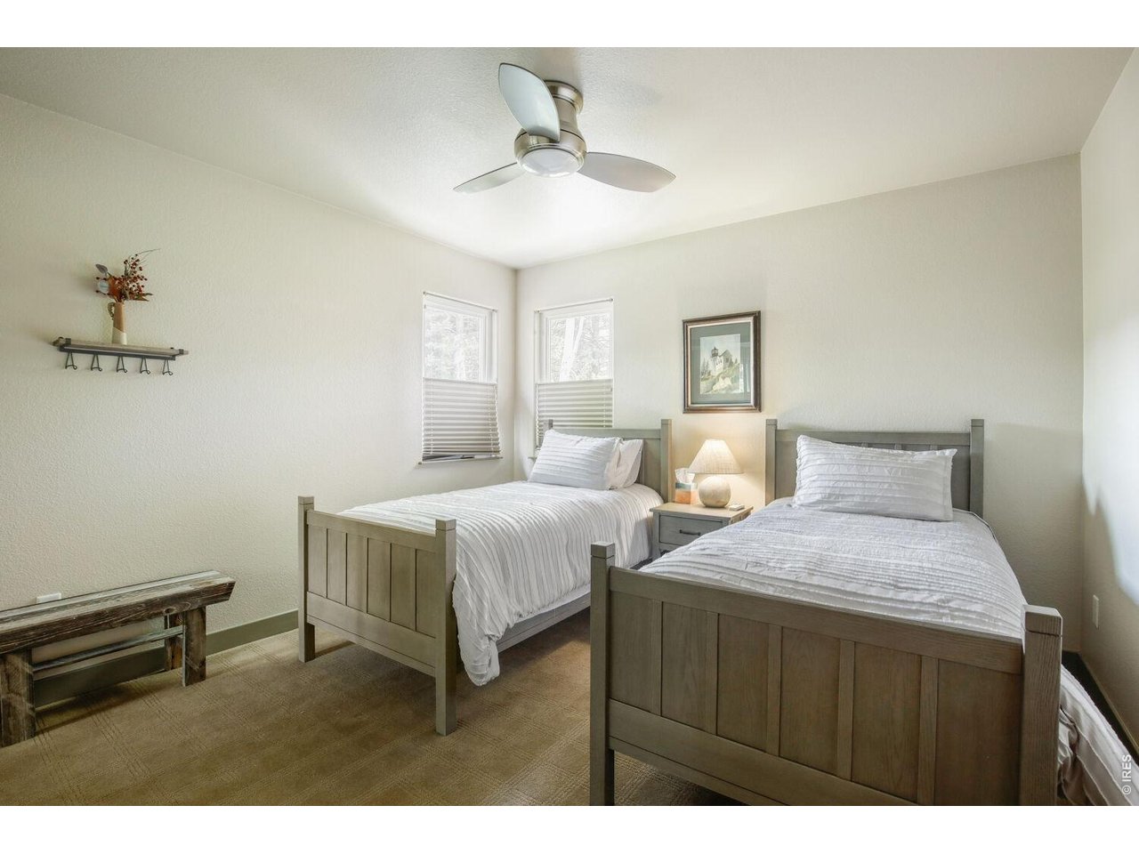 7550 Vardon Way Fort Collins, CO 80528 - Photo 20 of 29 a bedroom with two beds and a chandelier