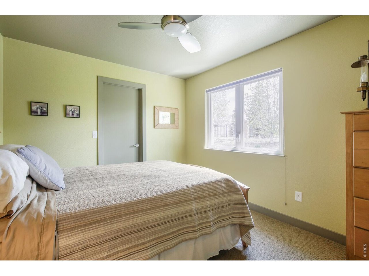 7550 Vardon Way Fort Collins, CO 80528 - Photo 21 of 29 a bedroom with a bed and wooden floor
