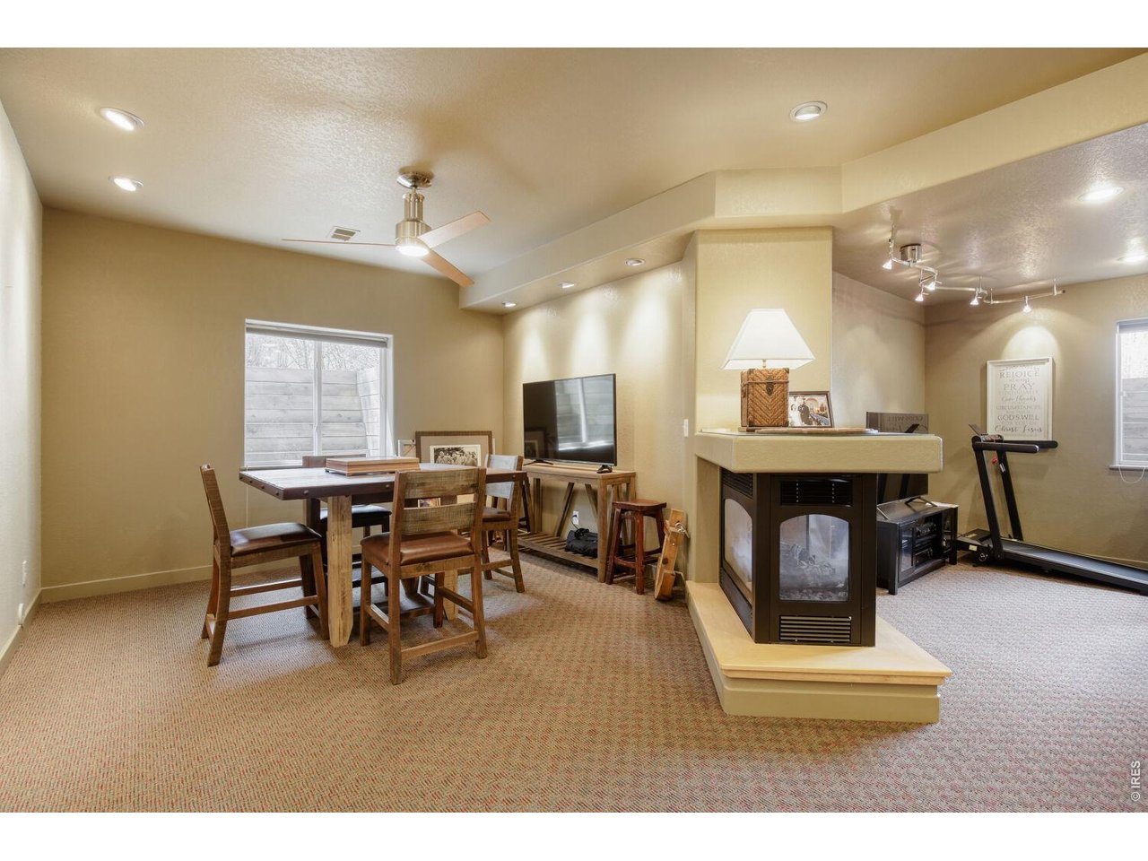 7550 Vardon Way Fort Collins, CO 80528 - Photo 24 of 29 a living room with furniture a fireplace and a flat screen tv