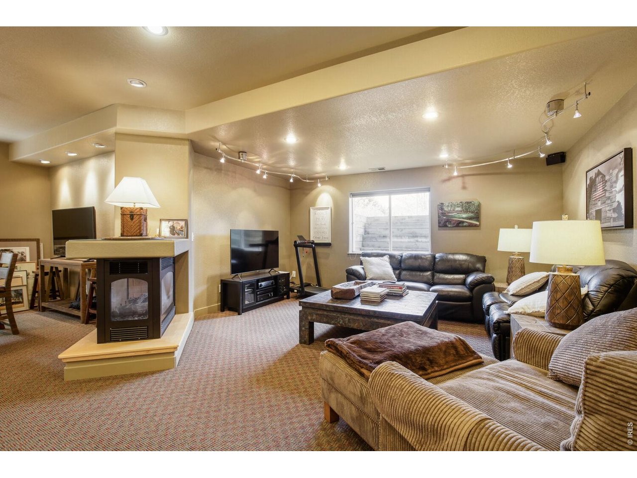 7550 Vardon Way Fort Collins, CO 80528 - Photo 25 of 29 a living room with furniture and a fireplace