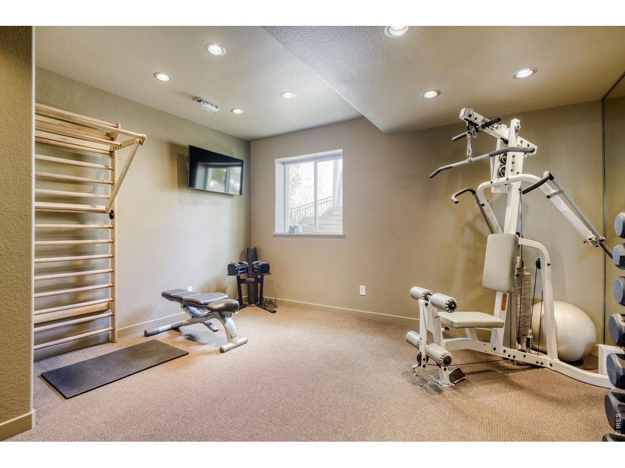 7550 Vardon Way Fort Collins, CO 80528 - Photo 26 of 29 a room with gym equipment and view of living room