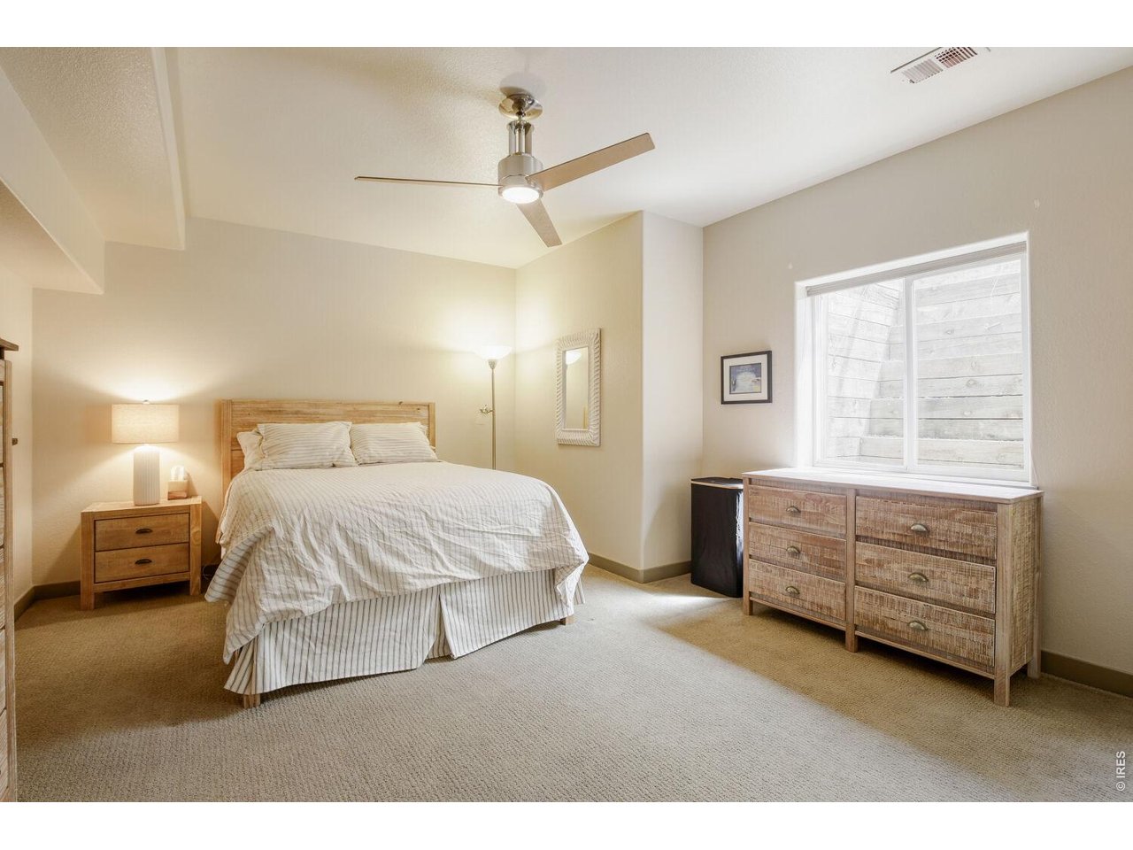 7550 Vardon Way Fort Collins, CO 80528 - Photo 27 of 29 a bedroom with a bed and a night stand