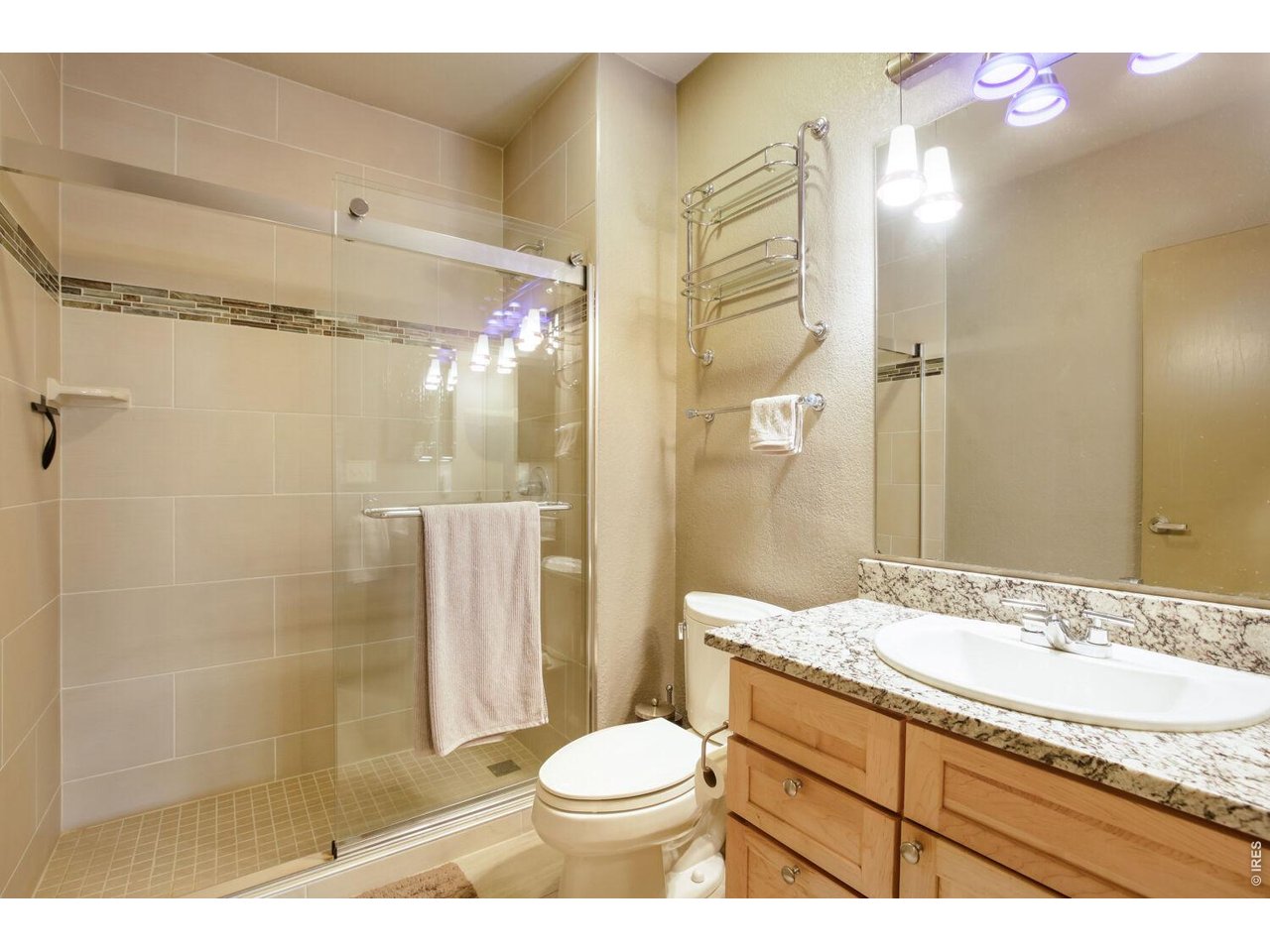 7550 Vardon Way Fort Collins, CO 80528 - Photo 29 of 29 a bathroom with a granite countertop sink toilet and shower