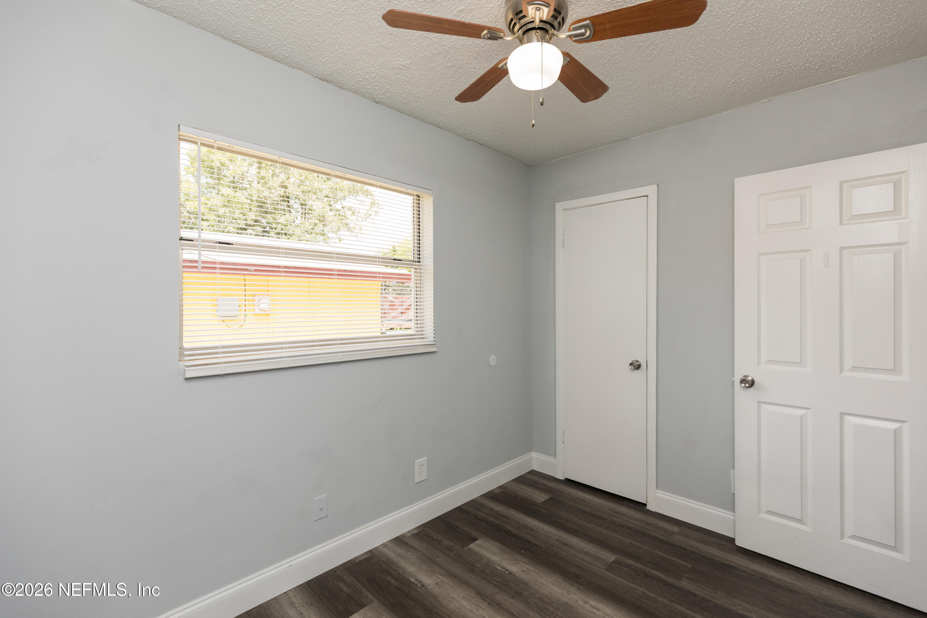 2255 West 13th Street Jacksonville, FL 32209 - Photo 15 of 29 a view of an empty room with wooden floor and a window