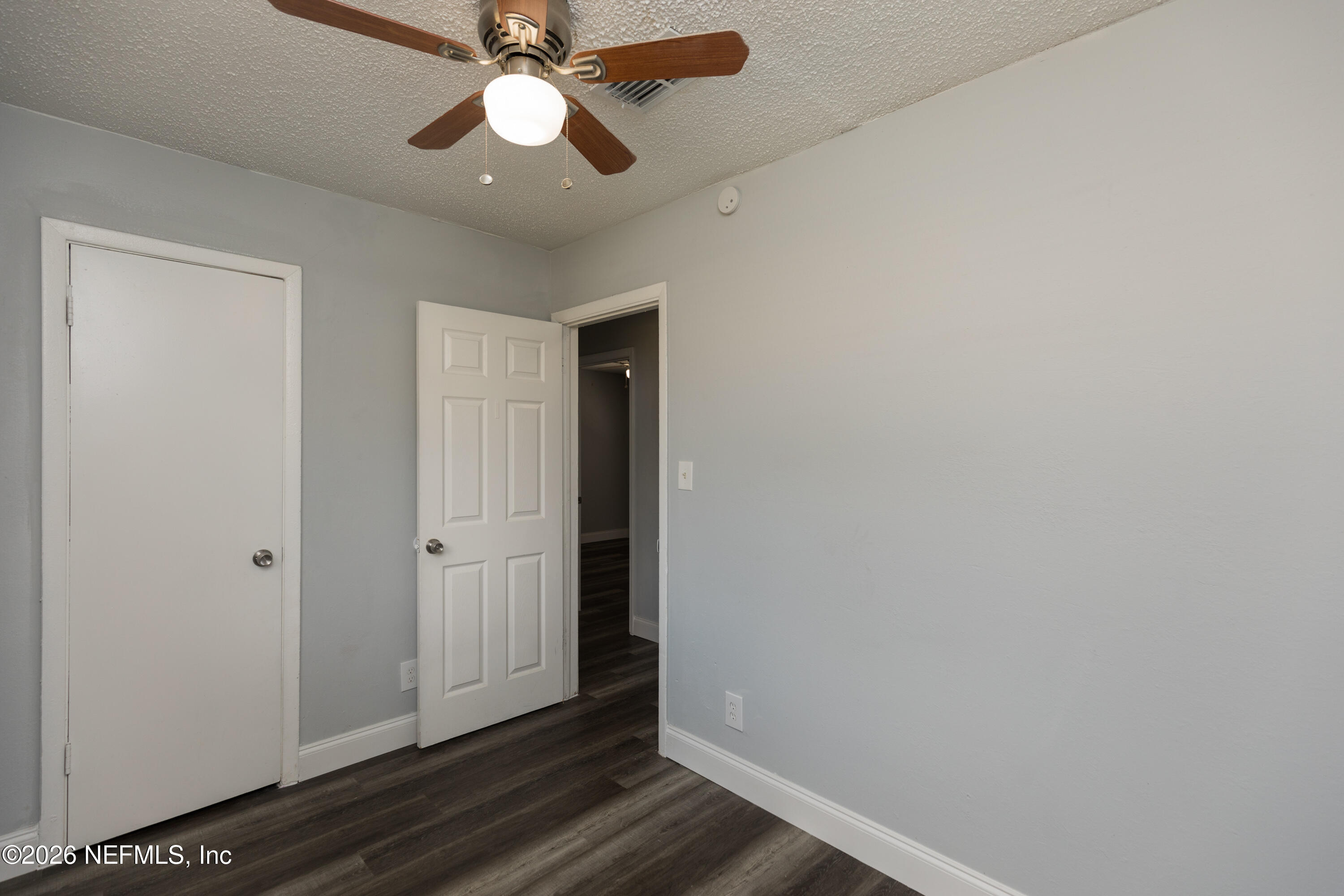 2255 West 13th Street Jacksonville, FL 32209 - Photo 16 of 29 an empty room with wooden floor closet and fan