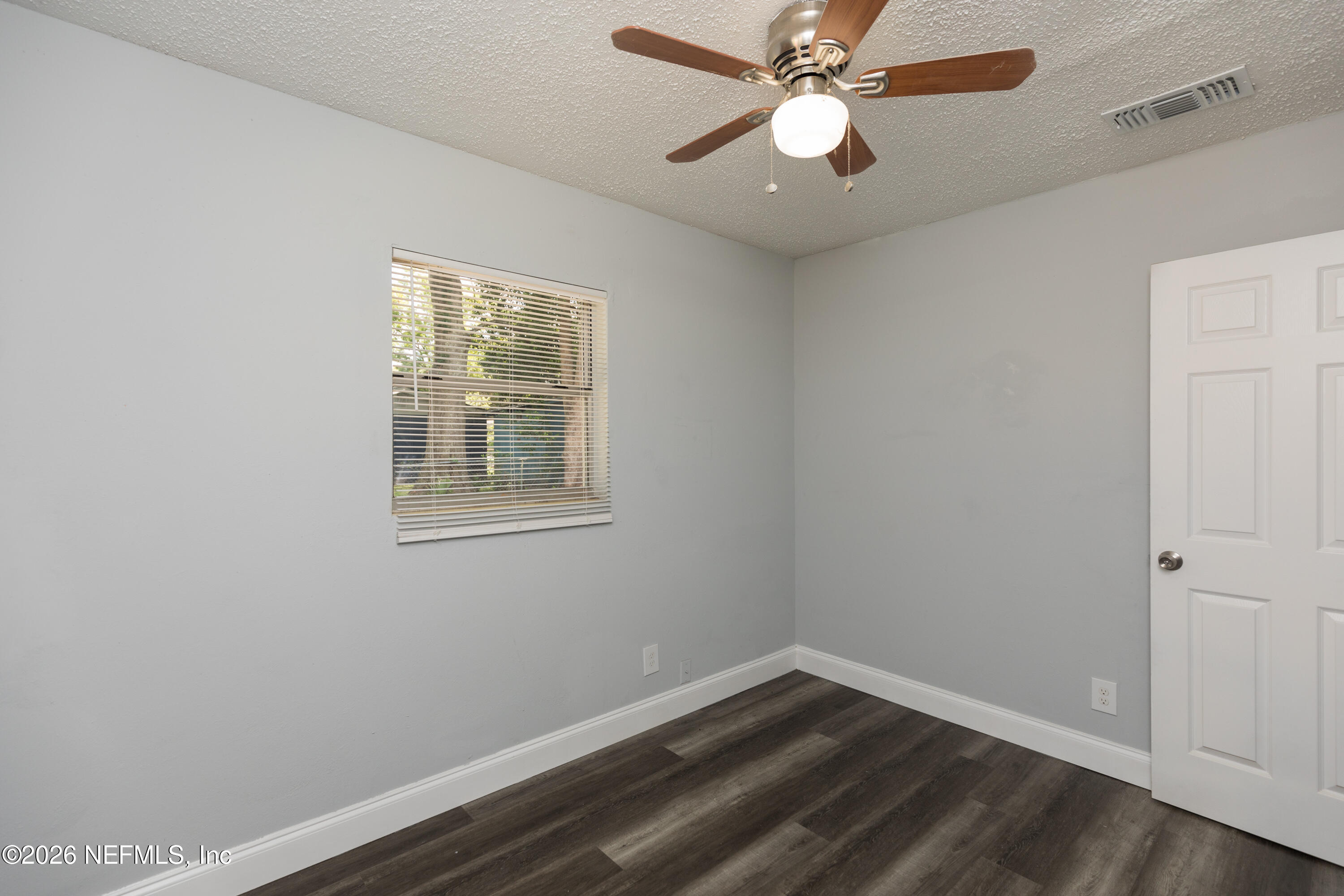 2255 West 13th Street Jacksonville, FL 32209 - Photo 19 of 29 an empty room with a window and a fan