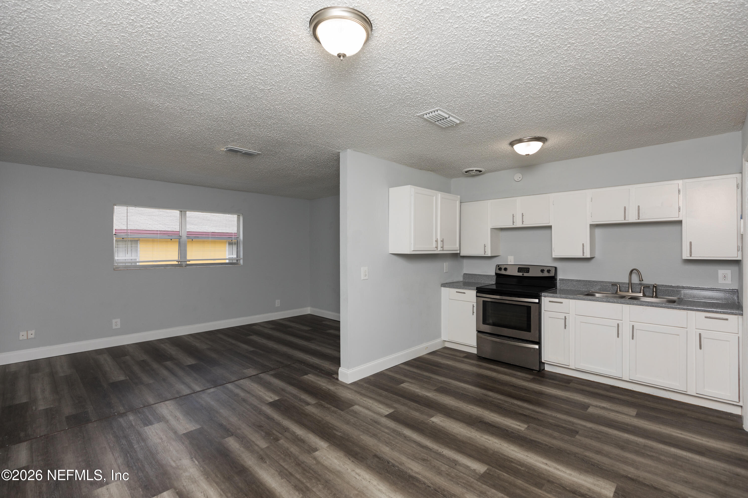 2255 West 13th Street Jacksonville, FL 32209 - Photo 2 of 29 a kitchen with granite countertop a stove top oven and sink