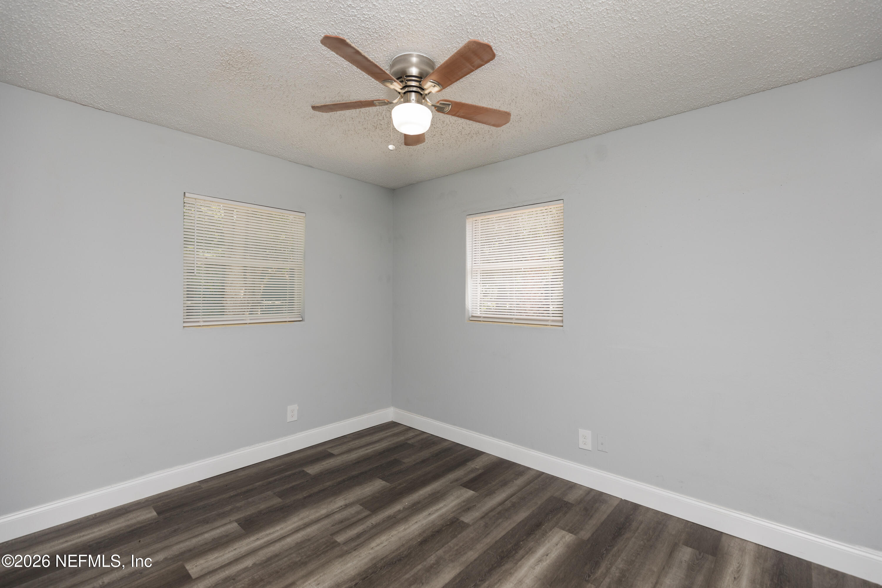 2255 West 13th Street Jacksonville, FL 32209 - Photo 21 of 29 an empty room with wooden floor and a ceiling fan