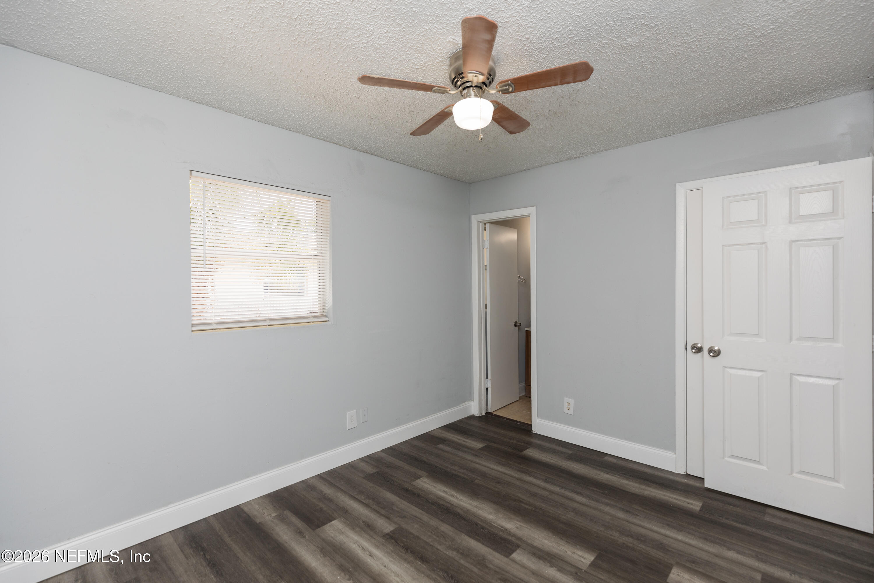 2255 West 13th Street Jacksonville, FL 32209 - Photo 22 of 29 an empty room with wooden floor fan and windows