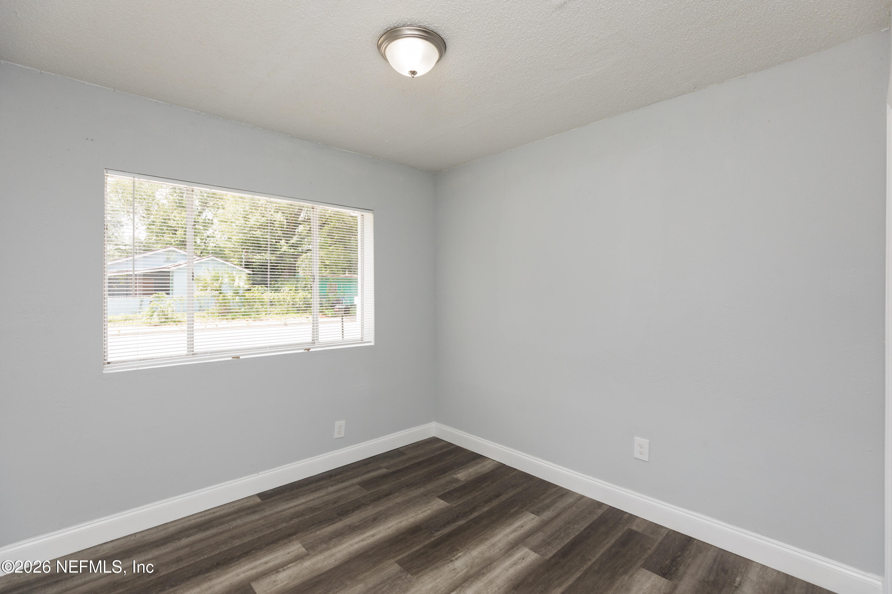 2255 West 13th Street Jacksonville, FL 32209 - Photo 27 of 29 an empty room with wooden floor and windows