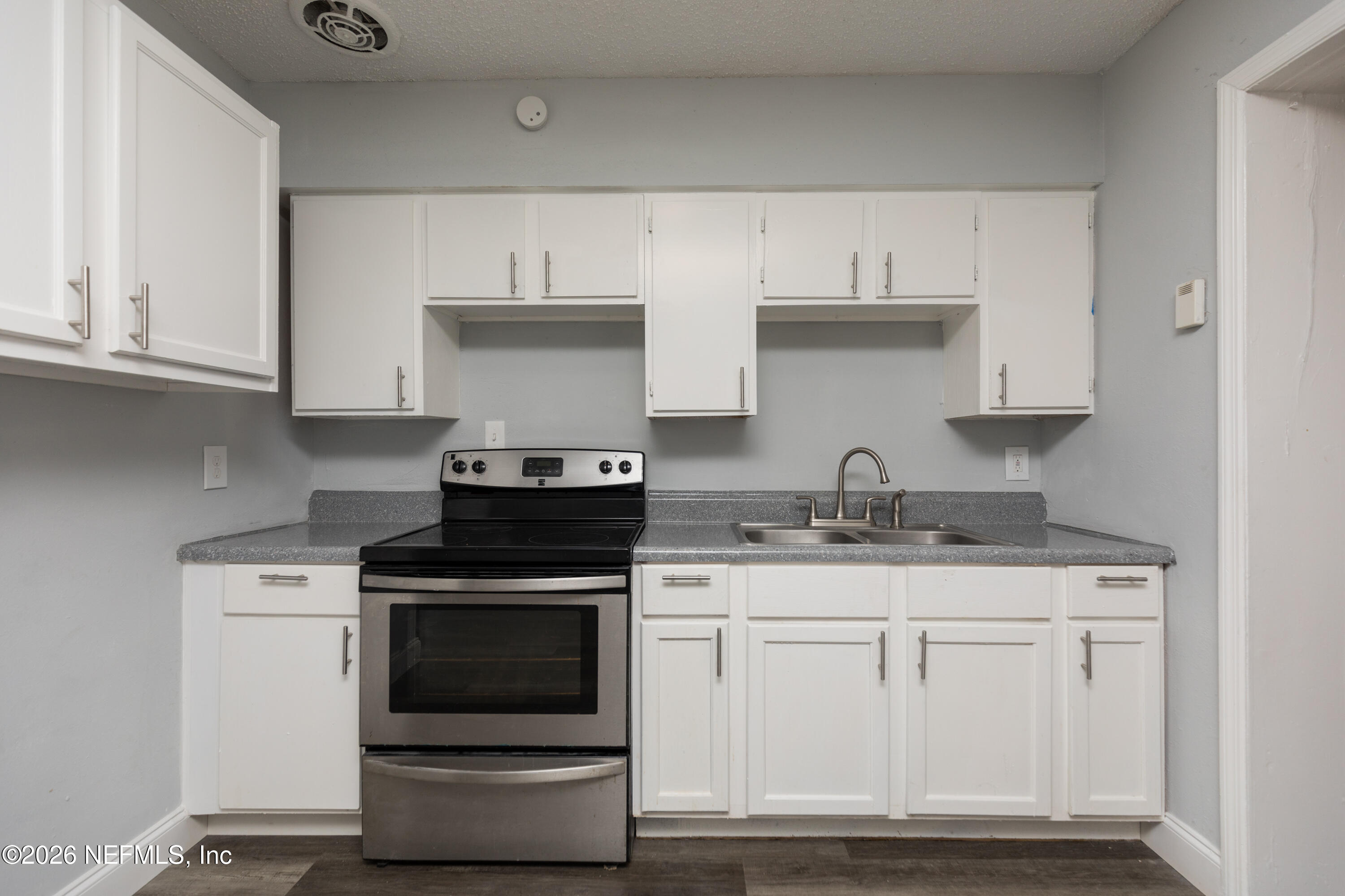 2255 West 13th Street Jacksonville, FL 32209 - Photo 3 of 29 a kitchen with white cabinets and appliances