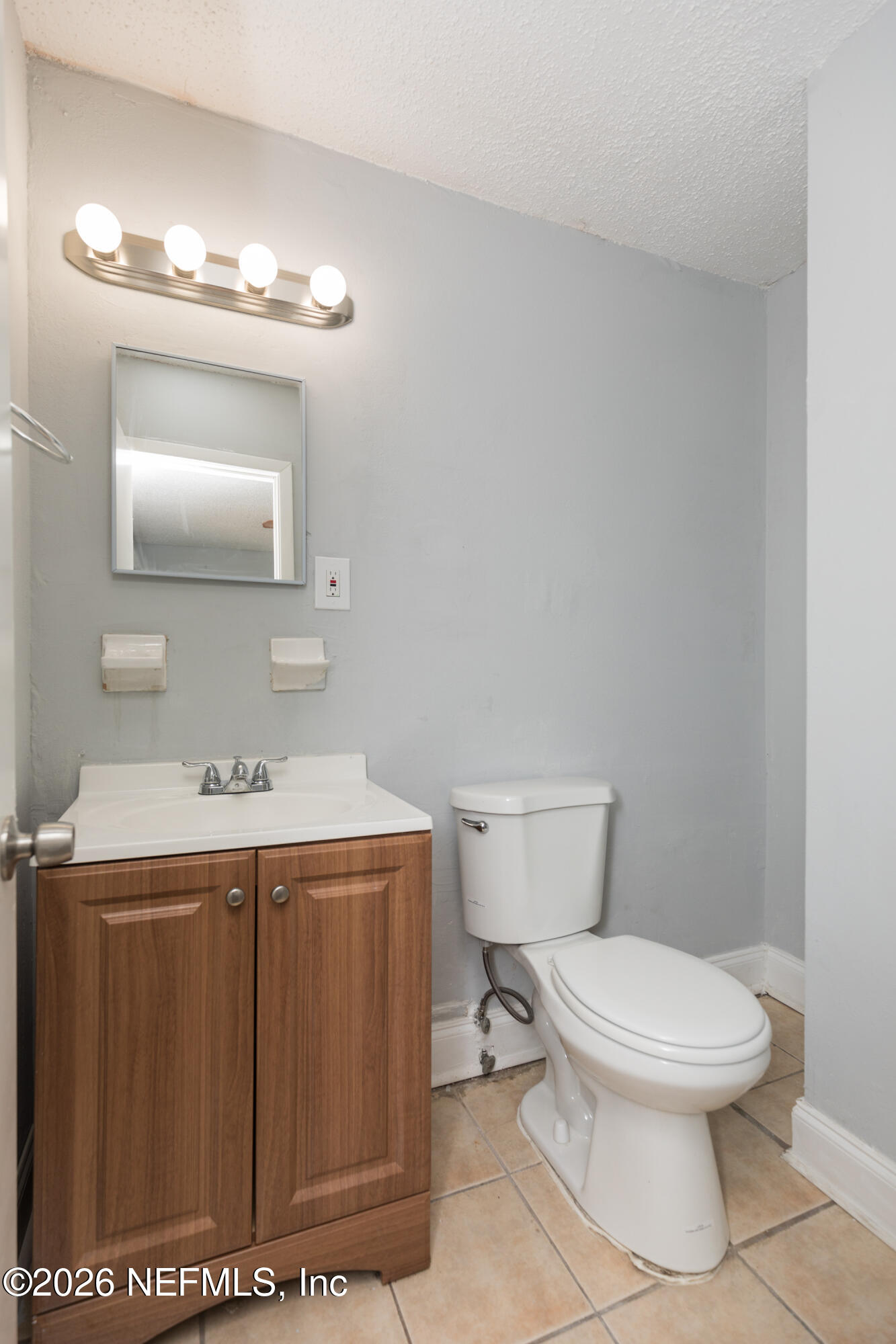 2255 West 13th Street Jacksonville, FL 32209 - Photo 6 of 29 a bathroom with a toilet a sink and mirror