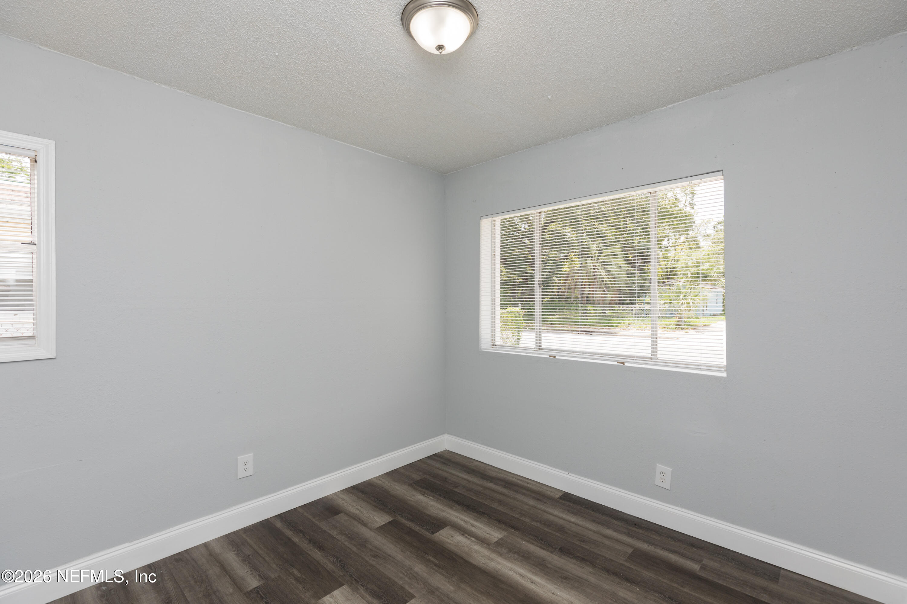 2255 West 13th Street Jacksonville, FL 32209 - Photo 8 of 29 a view of an empty room with wooden floor and a window