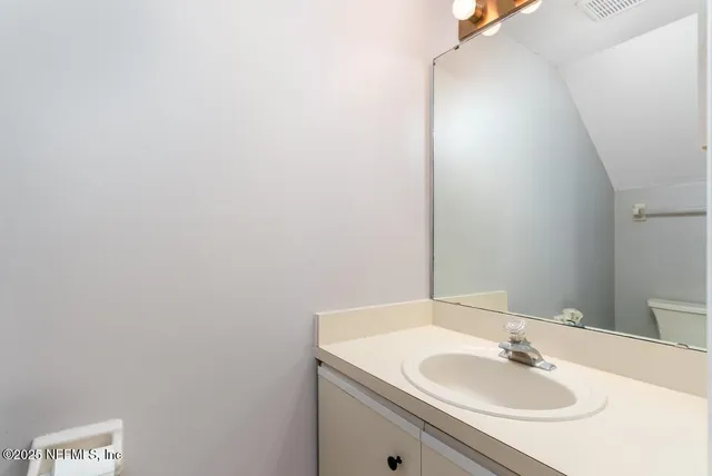 a view of a room with wooden floor and white walls