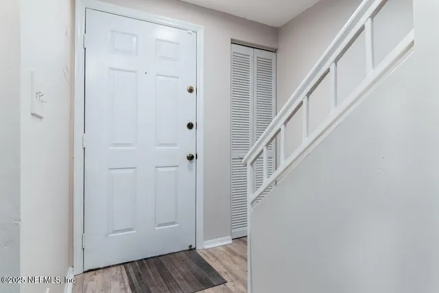 a view of empty room with wooden floor and fireplace