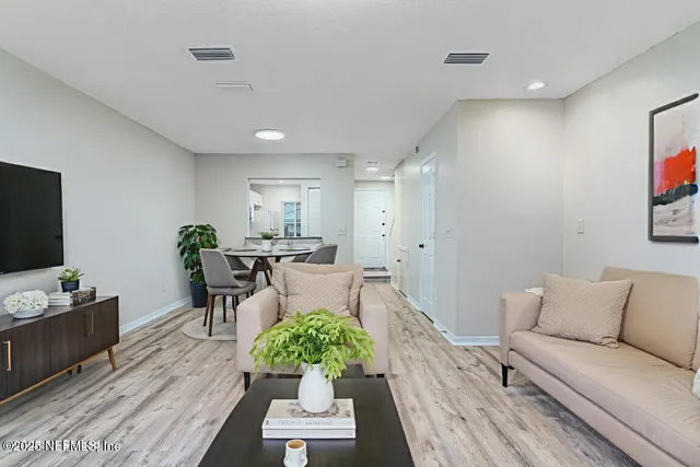 a view of empty room with wooden floor and fireplace