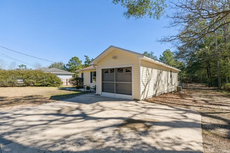 6127 Old Hickory Road Crestview, FL 32539 - Photo 3 of 32 a front view of a house with a yard and garage