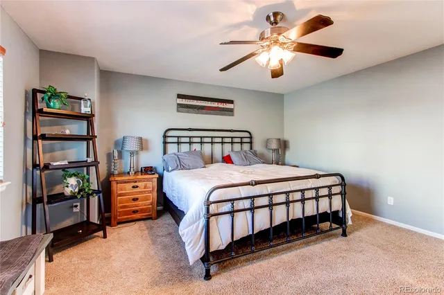 a bedroom with a large bed and a flat tv screen