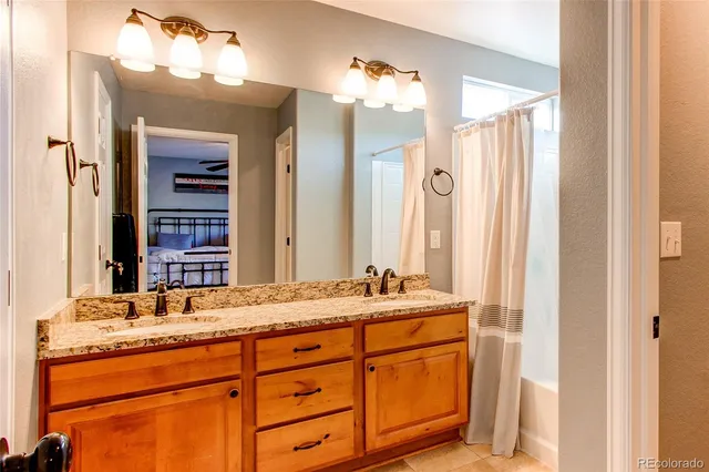 a bathroom with a granite countertop sink and a mirror