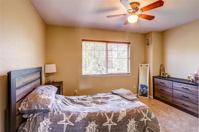 a room with baby crib and dresser