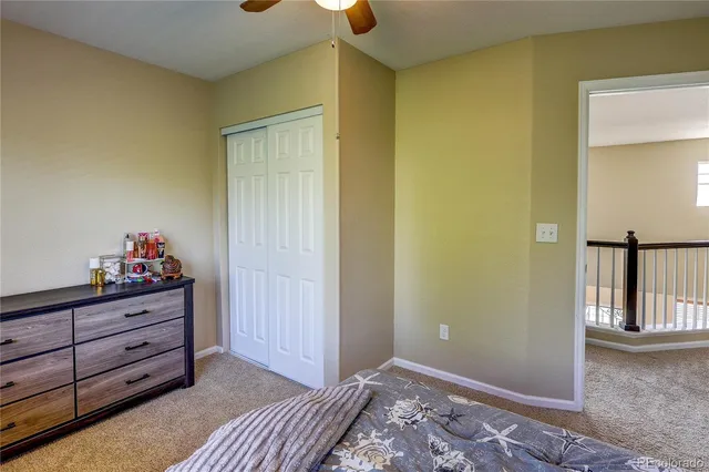 a bathroom with a granite countertop sink a toilet and a mirror