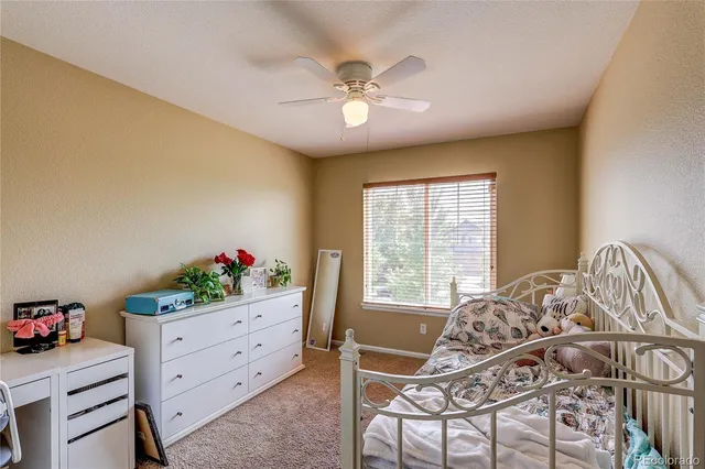 a bedroom with a bed and a table