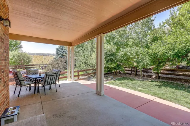 a backyard of a house with yard and trampoline