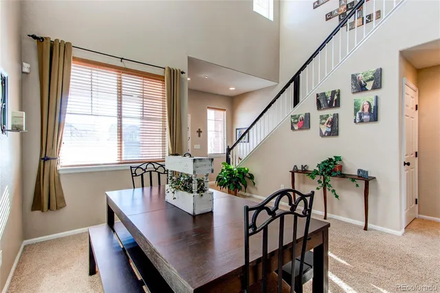 a view of a dining room with furniture and window