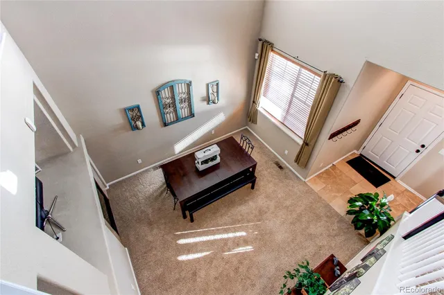 a living room with furniture and flowers