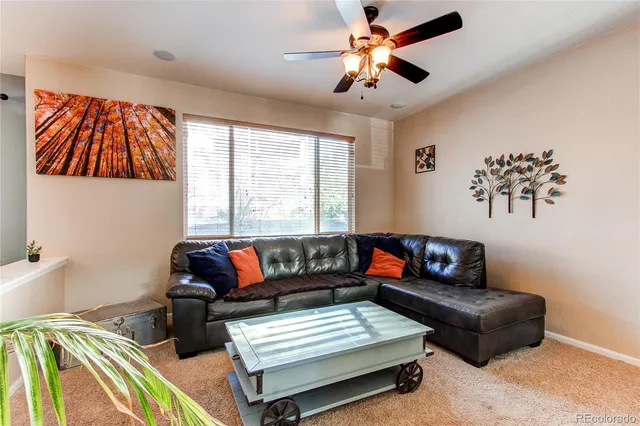 a bedroom with furniture and a large window