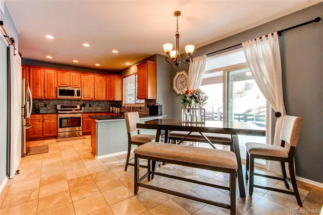 a living room with fireplace furniture and a large window