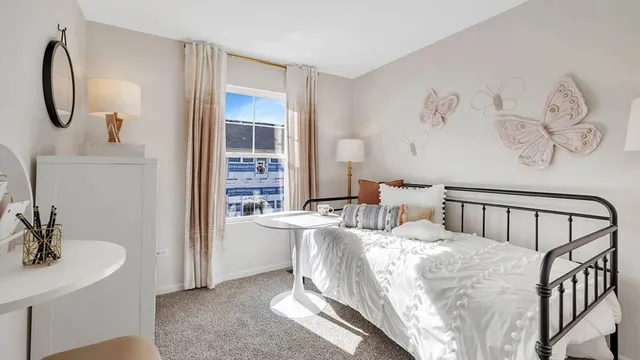 a bedroom with a bed and a table in it