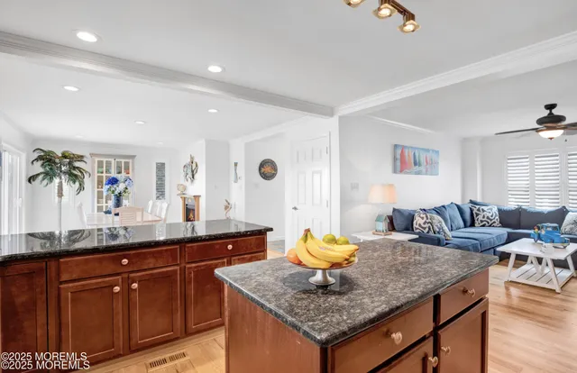 a living room with granite countertop furniture and wooden floor