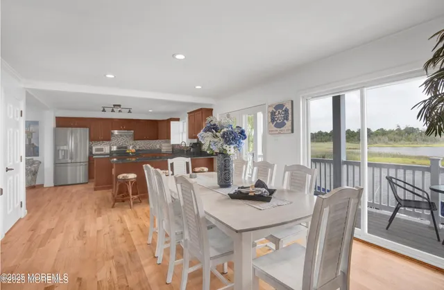 a dining room with furniture and wooden floor