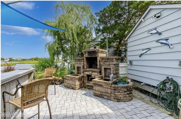 a view of backyard with outdoor seating and plants