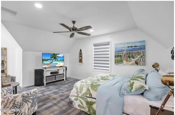 a bedroom with a bed table and chair